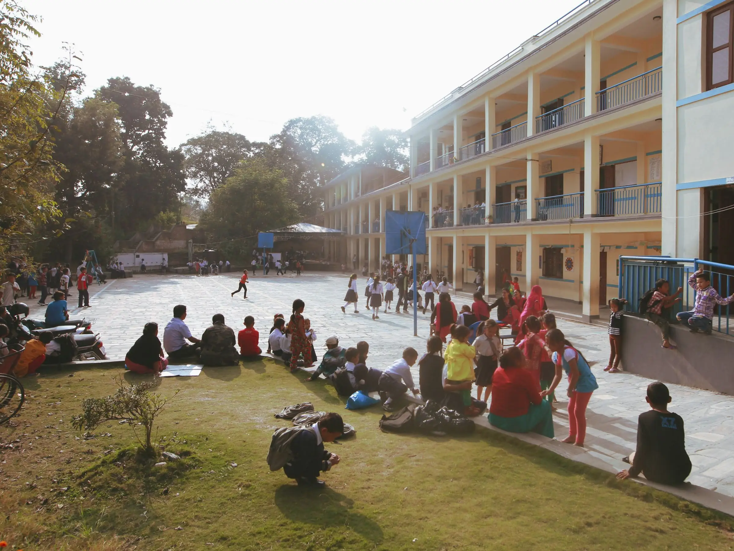 An Indian school courtyard and classroom block at break time